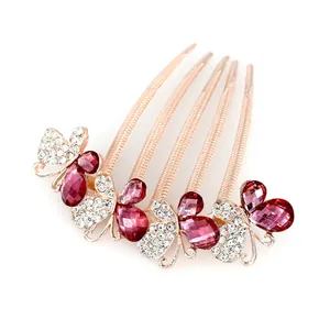 Rose gold butterfly hair comb with sparkling pink and white rhinestones for bridal styling