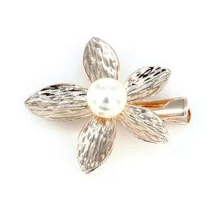Elegant gold metal flower hair clip with a textured finish and central white pearl accent
