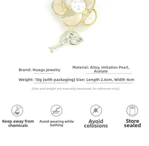 Detail of camellia brooch with cream acetate petals and a faux pearl, 2.6cm by 4.0cm
