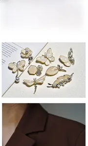 Detail of vintage gold butterfly brooches with mother-of-pearl and crystal accents