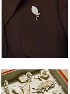 Detail of golden shell leaf brooch with pearls pinned on a coffee-colored blazer
