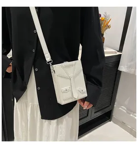 Detail of creative white suit-shaped mini crossbody bag with leather tie texture