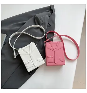 Detail of creative suit-style mini crossbody bags in white and pink lychee leather