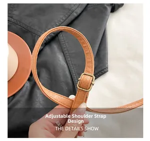 Detail of adjustable brown faux leather strap with vintage metal buckle and fine texture