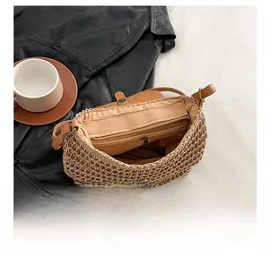 Internal view of straw saddle bag featuring zipper pocket and magnetic flap closure