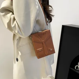 Unique brown suit-shaped PU leather crossbody bag with creative necktie and pocket details