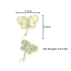 Elegant gold butterfly brooch with shell inlay and pearl drop, front and back views