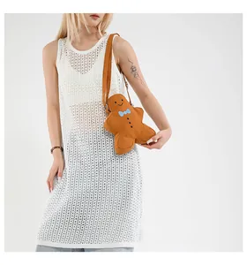Gingerbread man plush crossbody bag with blue bow and brown shoulder strap detail