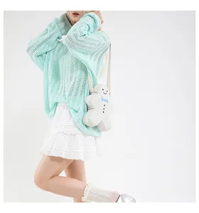 Close-up of a white plush gingerbread man crossbody bag with a blue bow tie and buttons