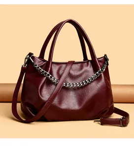 Detail of high-quality burgundy leather tote with a stylish silver thick chain accessory