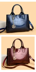 Vertical view of glossy crocodile embossed handbags in blue and wine red gradient
