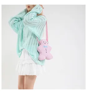 Pink gingerbread man crossbody bag shown on model with adjustable strap detail
