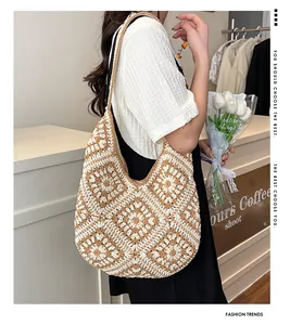 Detail of hand-crocheted floral shoulder bag in beige and brown bohemian tote style