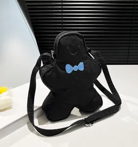 Zwarte peperkoekmannetje crossbodytas met blauwe strik en verstelbare schouderband