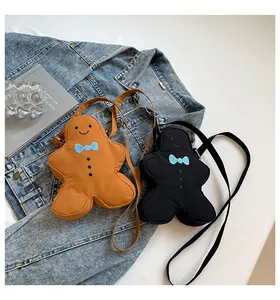 Detail of gingerbread man crossbody bags in brown and black with blue bow tie accents