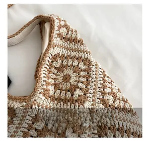 Close-up of handmade crochet shoulder bag featuring bohemian floral pattern texture