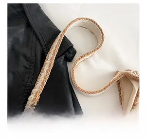 Detail showing the wide crochet shoulder strap and woven texture of the beige tote bag