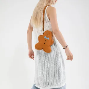 Gingerbread man plush crossbody bag with blue bow tie and brown shoulder strap