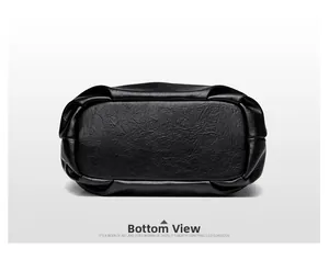 Detailed bottom view of large capacity black leather tote bag with stylish pleated edges