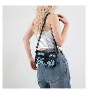 Detail of the blue snakeskin pattern box bag with black metal clasp and rivets
