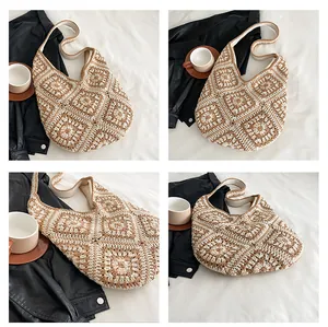 Detail of bohemian crochet hobo bag with grandma square patterns and wide shoulder strap