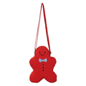 Gingerbread man shaped red crossbody bag with blue bow and shoulder strap for Christmas