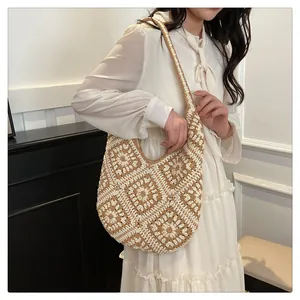 Detail of hand-crocheted shoulder bag with retro floral grandmother squares pattern