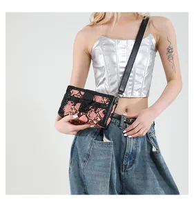 Pink snake pattern trunk bag with black metal lock and adjustable shoulder strap