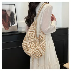 Detail of handmade crochet shoulder bag featuring beige floral mandala weave patterns