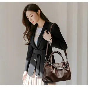 Large dark brown leather tote bag with silver chain and detachable shoulder strap