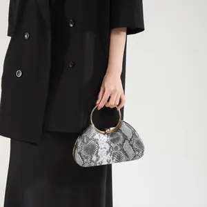 Elegant snake print clutch bag with golden circular handle and metallic clasp