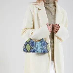 Elegant snakeskin patterned evening clutch bag with a golden circular handle for women