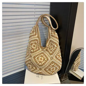 Detail of hand-crocheted granny square tote bag with vintage brown and beige floral pattern