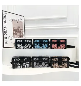 Detailed collection of mini trunk bags in snake skin and zebra prints with metal hardware