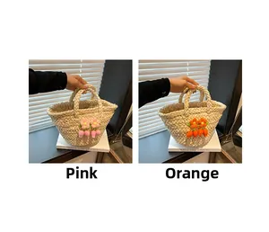Detail view of woven straw handbags featuring 3D floral accents in pink and orange colors