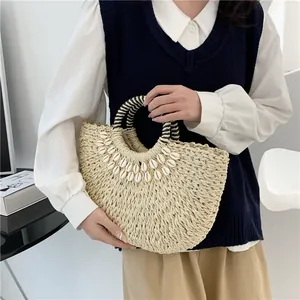 Handgewebte Strohtasche in Halbmodform mit Muschelbesatz für den Strandurlaub