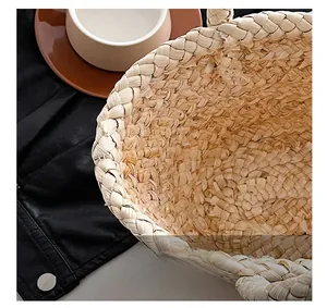 Close-up of handmade straw bag showing intricate weave texture and secure clasp detail