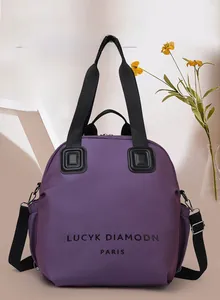 Detail of purple canvas backpack showing Lucy Diamond Paris print and black straps