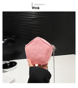 Detailed view of pink star-stitched mini crossbody bag with a delicate metal chain strap