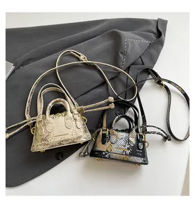 Makroaufnahme von Schlangenmuster-Beuteltaschen in Champagner und Metallic-Farben