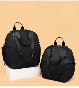 Close-up of black nylon multi-functional bag showing four-way carry strap details