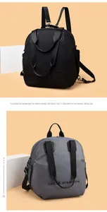 Detail view of multi-functional backpacks with top handles in black and grey nylon fabric