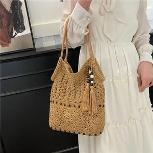 Handmade crochet straw tote bag with mandala floral patterns and bohemian tassel detail