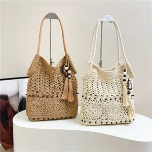 Bohemian crochet shoulder bag with floral hollow patterns and fringe tassel detail