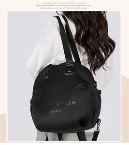 Detail of black nylon multi-purpose bag showing the logo and side drawstring pocket