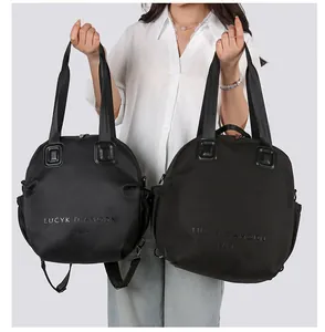LUCYK DIAMODN PARIS black nylon handbags in large and small sizes shown by a model