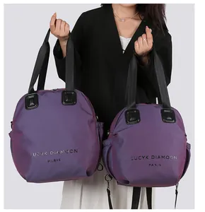 Macro shot of durable purple textured nylon fabric and brand lettering on two tote bags