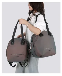 Detail of a metallic iridescent backpack with side pockets and a logo strap for women
