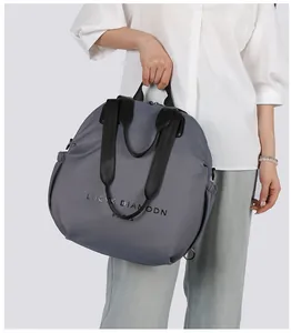 Detail of grey nylon tote bag with drawstring side pocket and LUCYK DIAMODN text