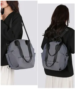 Detailed view of gray multi-functional nylon bag used as a crossbody and backpack